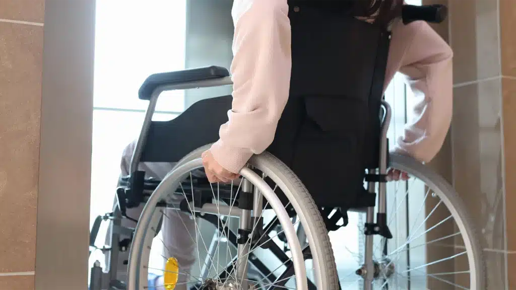Island Elevator Accessibility - Disabled Woman in Wheelchair Entering Elevator